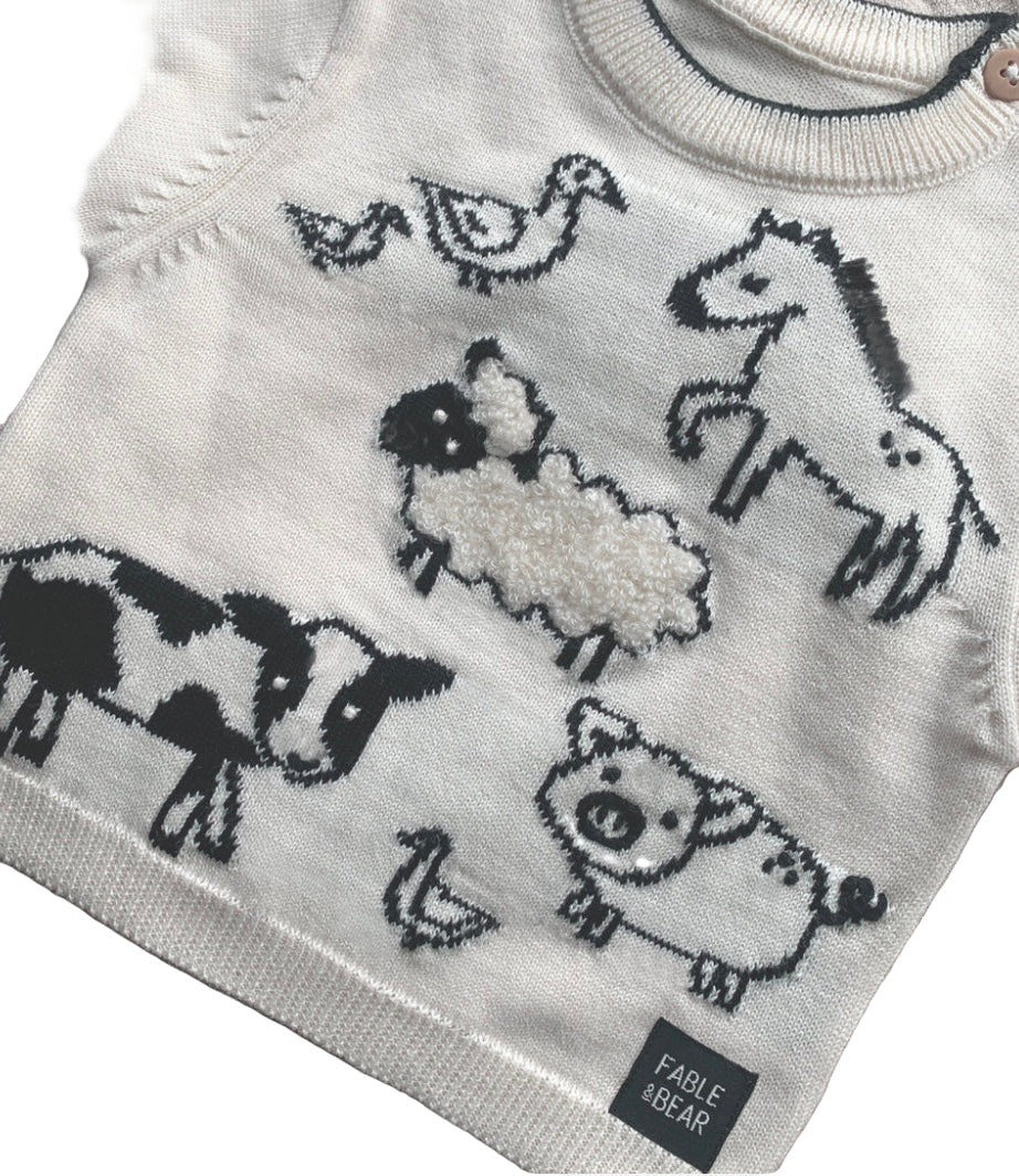 Children's sweater with farm animal patterns and Fable & Bear branding.